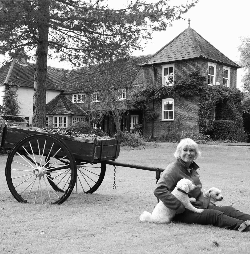owner in front of the house and barrow with pets in hands