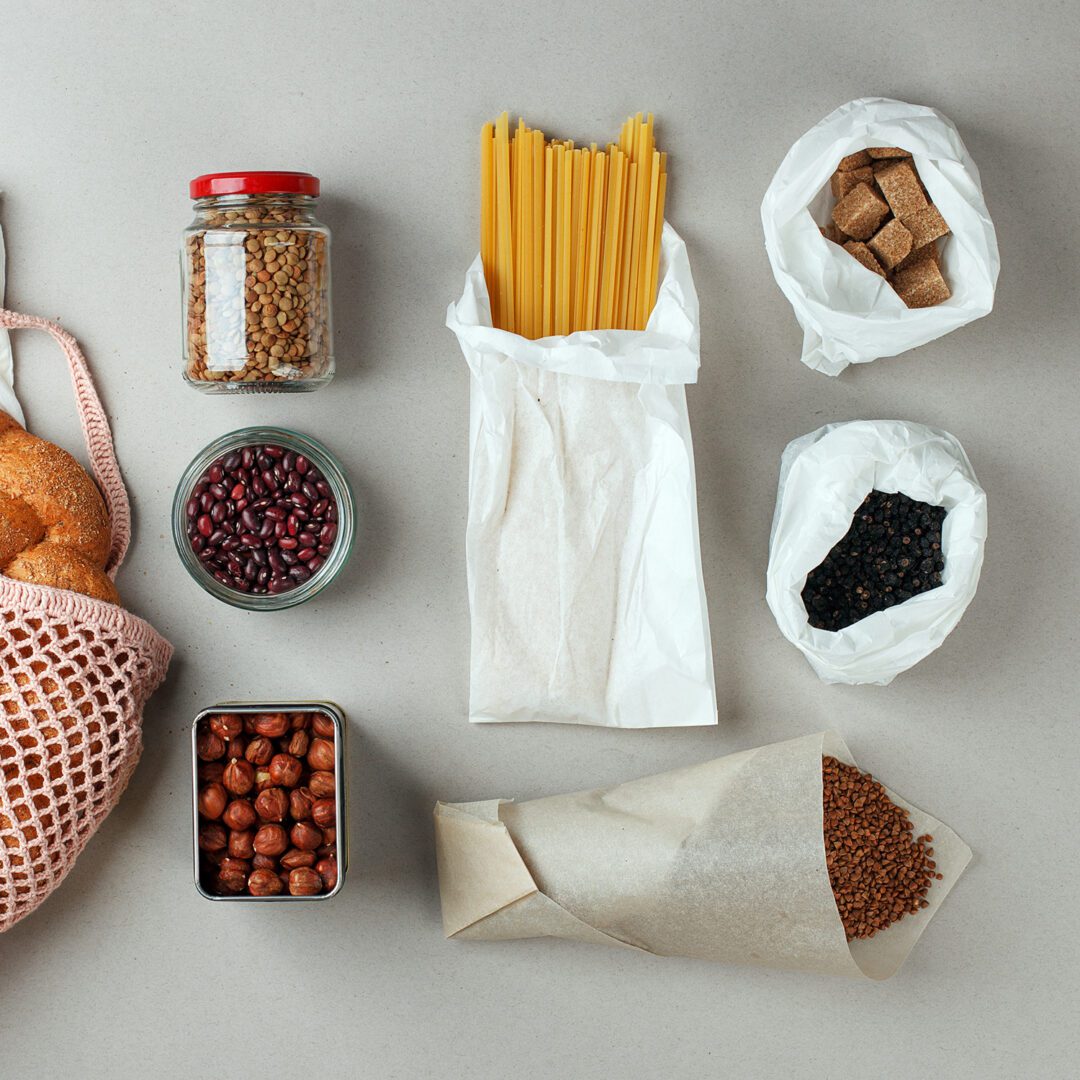 zero waste food shopping. eco natural bags and glass jar with food, eco friendly, flat lay. sustainable lifestyle concept. plastic free items. reuse, reduce, recycle, refuse. groceries in eco bags